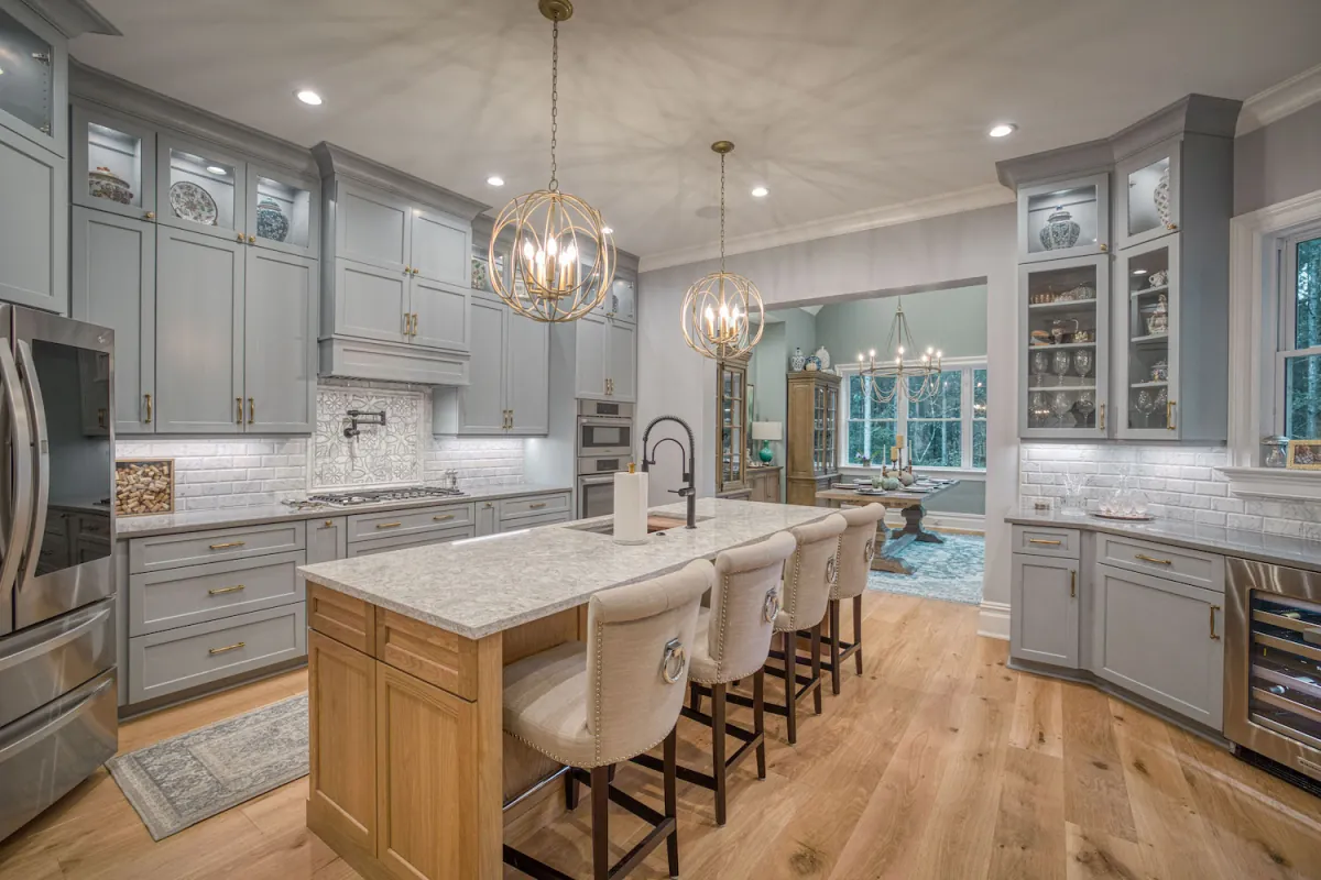 Luxury kitchen interior with custom cabinetry, marble island, and pendant lighting by Breen Development in Hickory NC